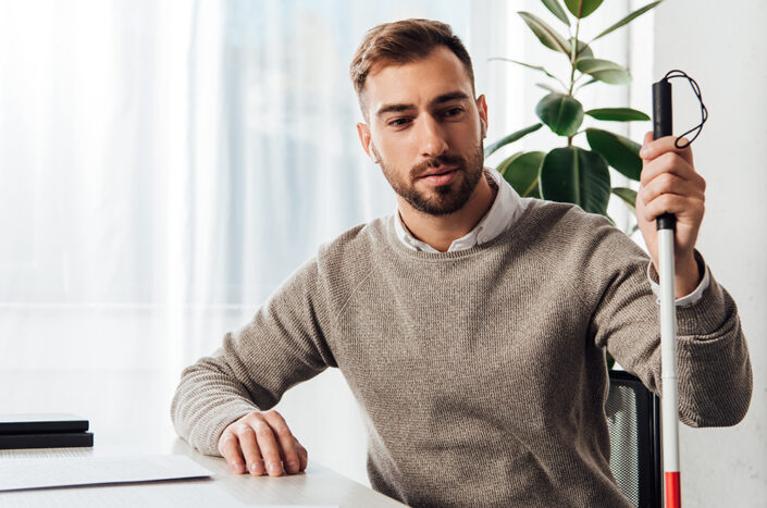 Visually impaired male at work