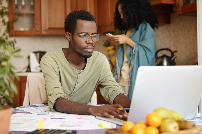 African male sorting paperwork