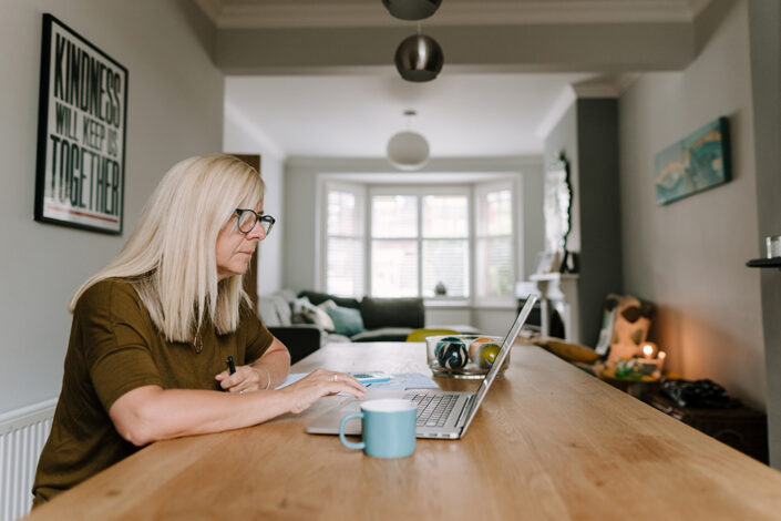 Woman working from home at her dining room table