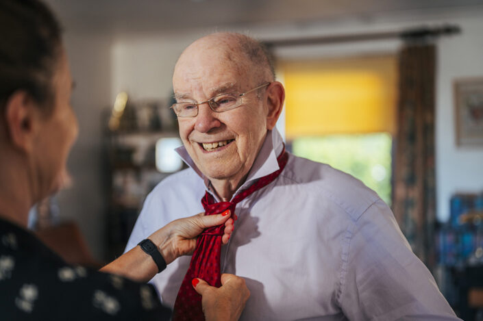 Woman adjusting a mans tie