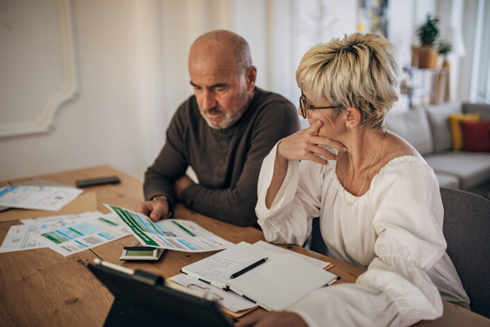 Older couple pondering bills