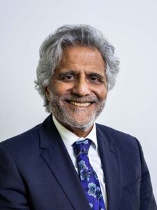 Photo of Professor Binna Kandola OBE wearing a navy suit