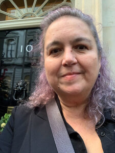 Photo of Catherine Bates, Cabinet Office Grief Cafe standing outside number 10