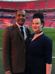 Photo of Clarke and Carrie Carlisle standing in a football ground