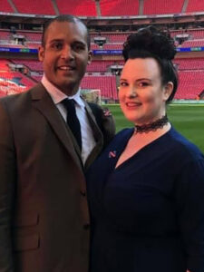 Photo of Clarke and Carrie Carlisle standing in a football ground