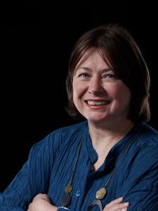Photo of Janine Chandler wearing a dark blue top