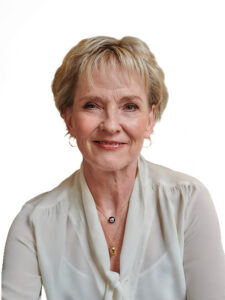 Photo of Julia Samuel MBE wearing a cream blouse