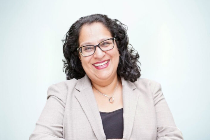 Photo of Mel Nebhrajani CB, Charity for Civil Servants Trustee wearing a black top and beige jacket