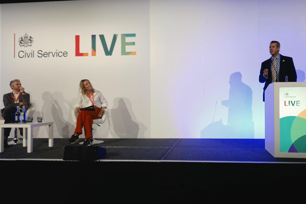 Photo of Antonio Romeo and Jonathan Freeman on the centre stage at Civil Service Live London