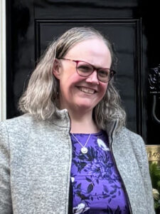 Photo of Keela Shackell Smith Cabinet Office Grief Cafe standing in front of 10 Downing Street