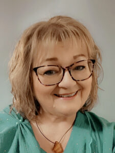Photo of Tess Sanderson, Find Your Happy Wellbeing wearing a green top