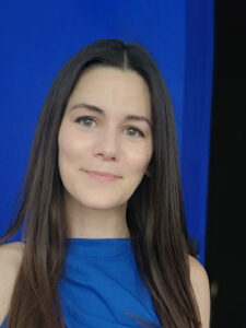 Photo of Charlotte Linacre, Civil Service Grief Cafe wearing a blue sleeveless top
